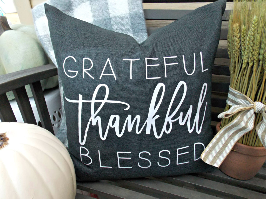 Slate gray throw pillow that says "grateful thankful blessed" in a fall farmhouse decor font