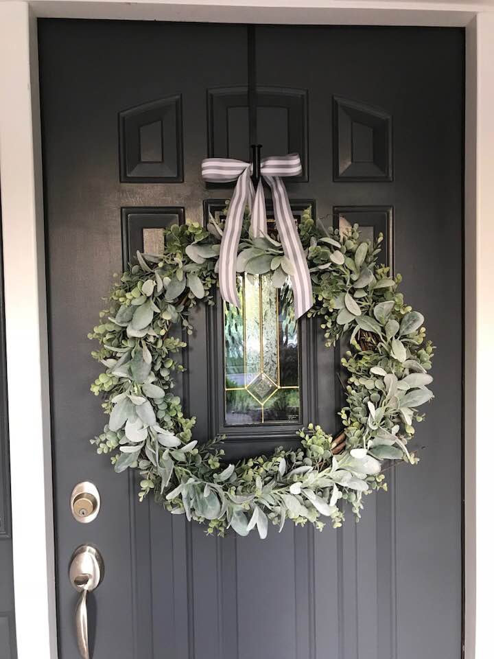 Farhouse wreath hanging on a black door